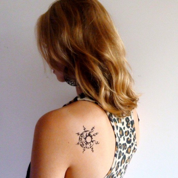 Small tribal sun-moon tattoo behind the shoulder: inked placement tattoo photo