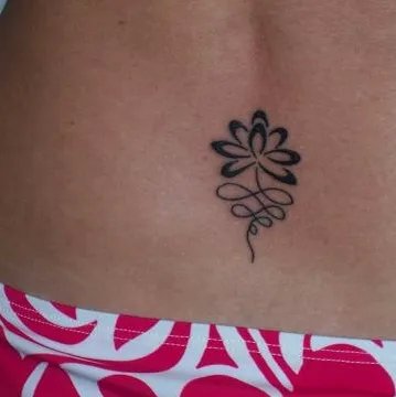 Claire - lotus lower back: real inked placement tattoo photo thumbnail