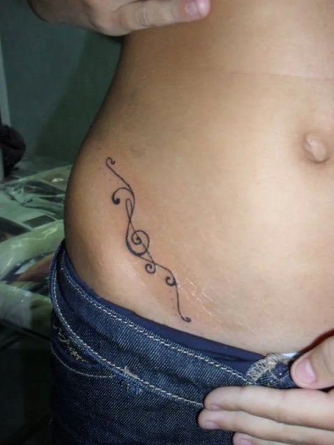 Rosanna - Treble clef swirls: real inked placement tattoo photo thumbnail