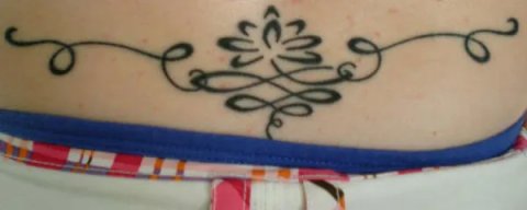 Tina - Lotus lower back: real inked placement tattoo photo thumbnail